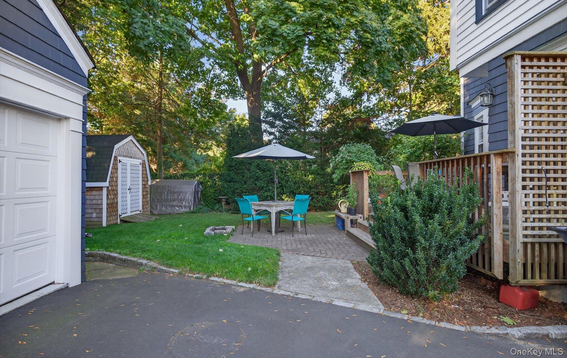 7 Ransom Avenue Sea Cliff, NY 11579 - Photo 39 of 42 a view of a chair and table in backyard of the house