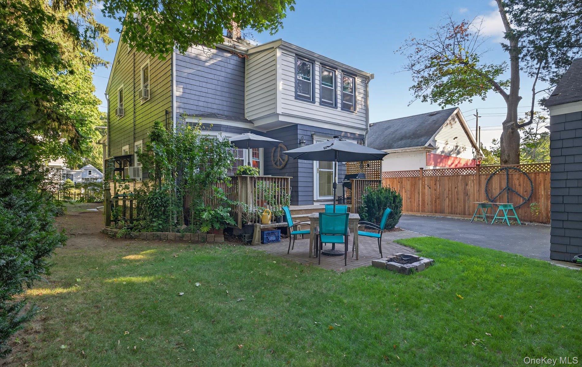 7 Ransom Avenue Sea Cliff, NY 11579 - Photo 42 of 42 a view of a chair and table in backyard of the house