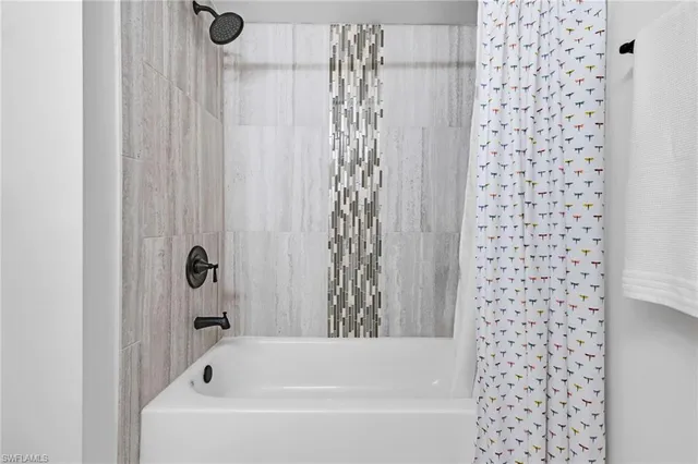 a bathroom with a bathtub and shower