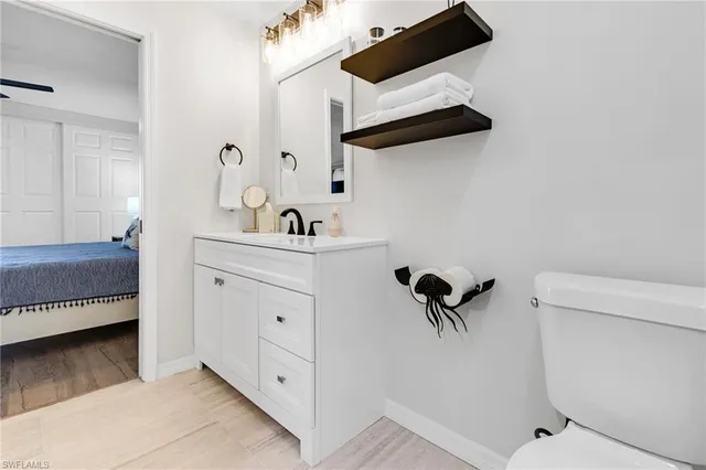 a bathroom with a sink a toilet and a mirror