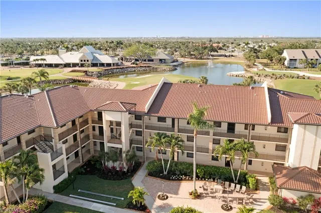 an aerial view of residential houses with outdoor space and lake view