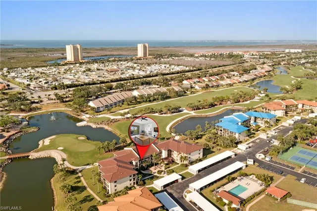 an aerial view of residential building with outdoor space and lake view