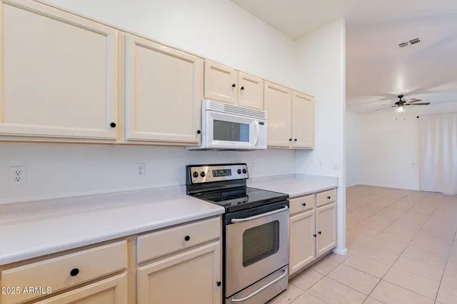 a kitchen with granite countertop white cabinets stainless steel appliances and sink