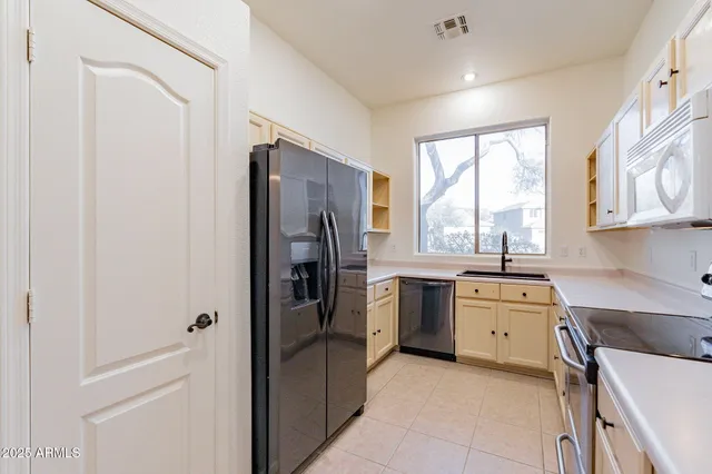 a kitchen with a refrigerator stove and sink