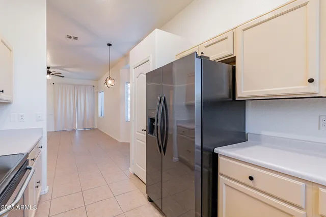 a kitchen with a refrigerator and cabinets