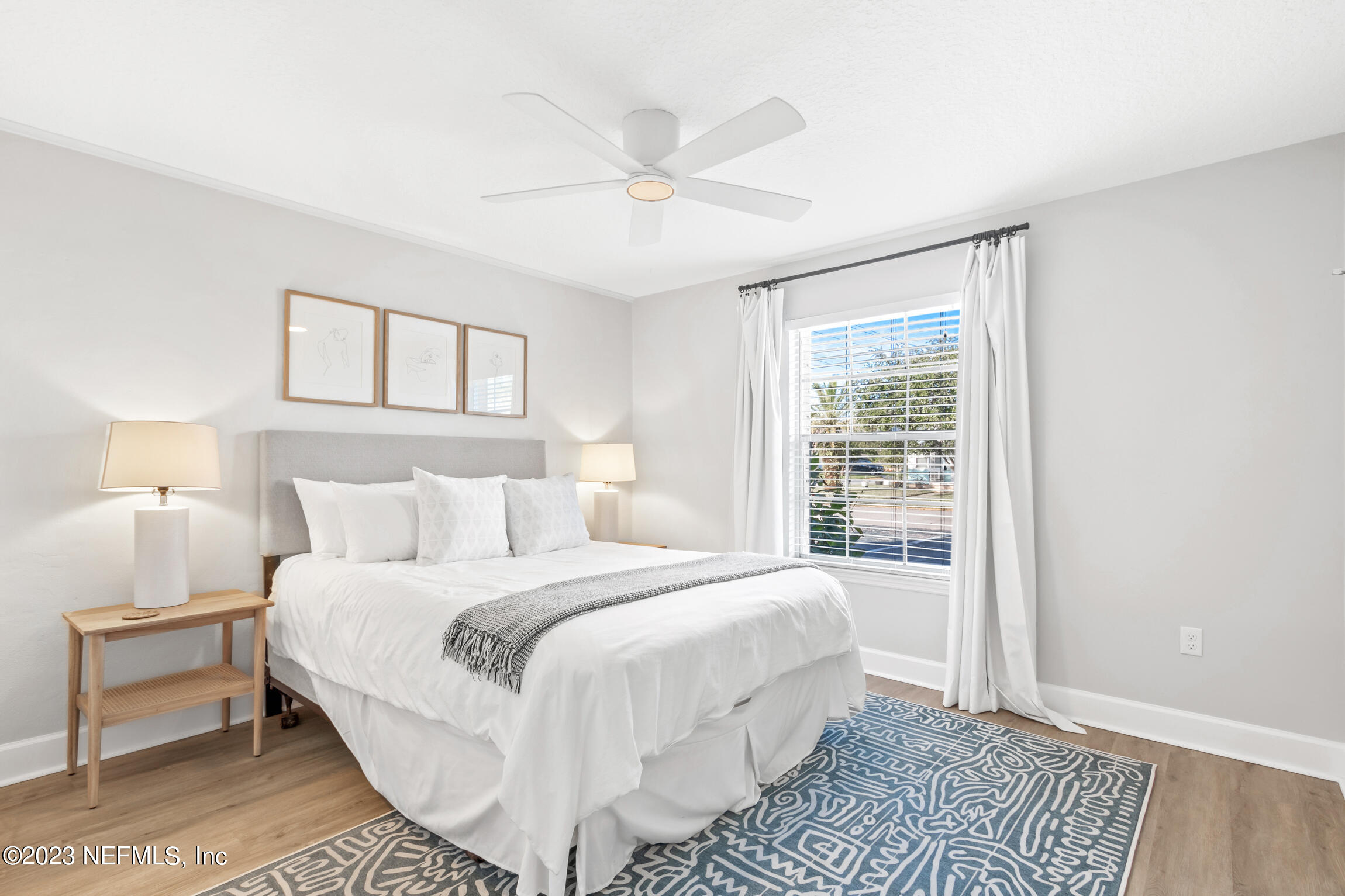 405 Flagler Boulevard, Unit 2A St. Augustine, FL 32080 - Photo 13 of 30 a bedroom with a large bed and a window