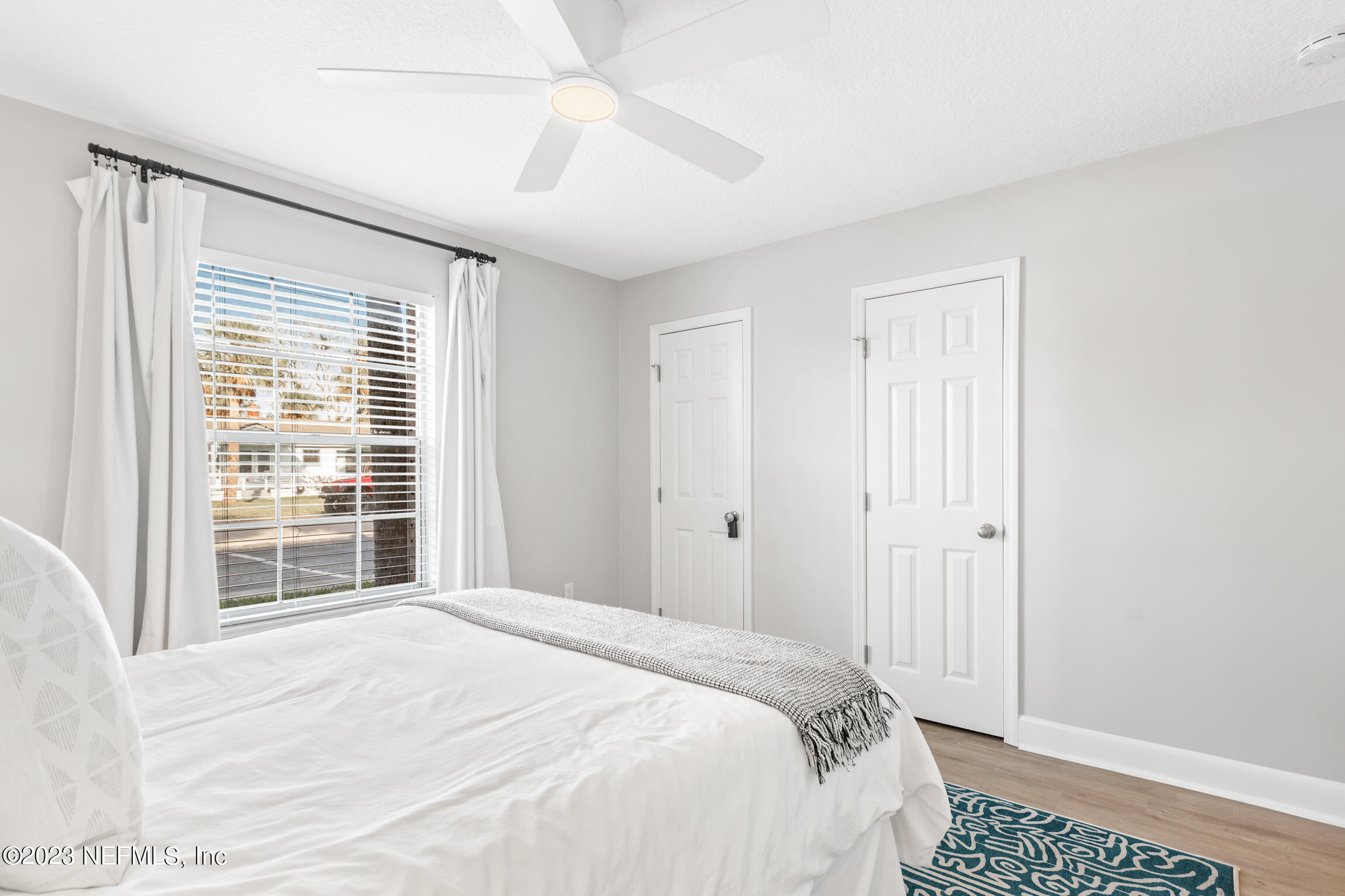 405 Flagler Boulevard, Unit 2A St. Augustine, FL 32080 - Photo 14 of 30 a bedroom with a bed and a window