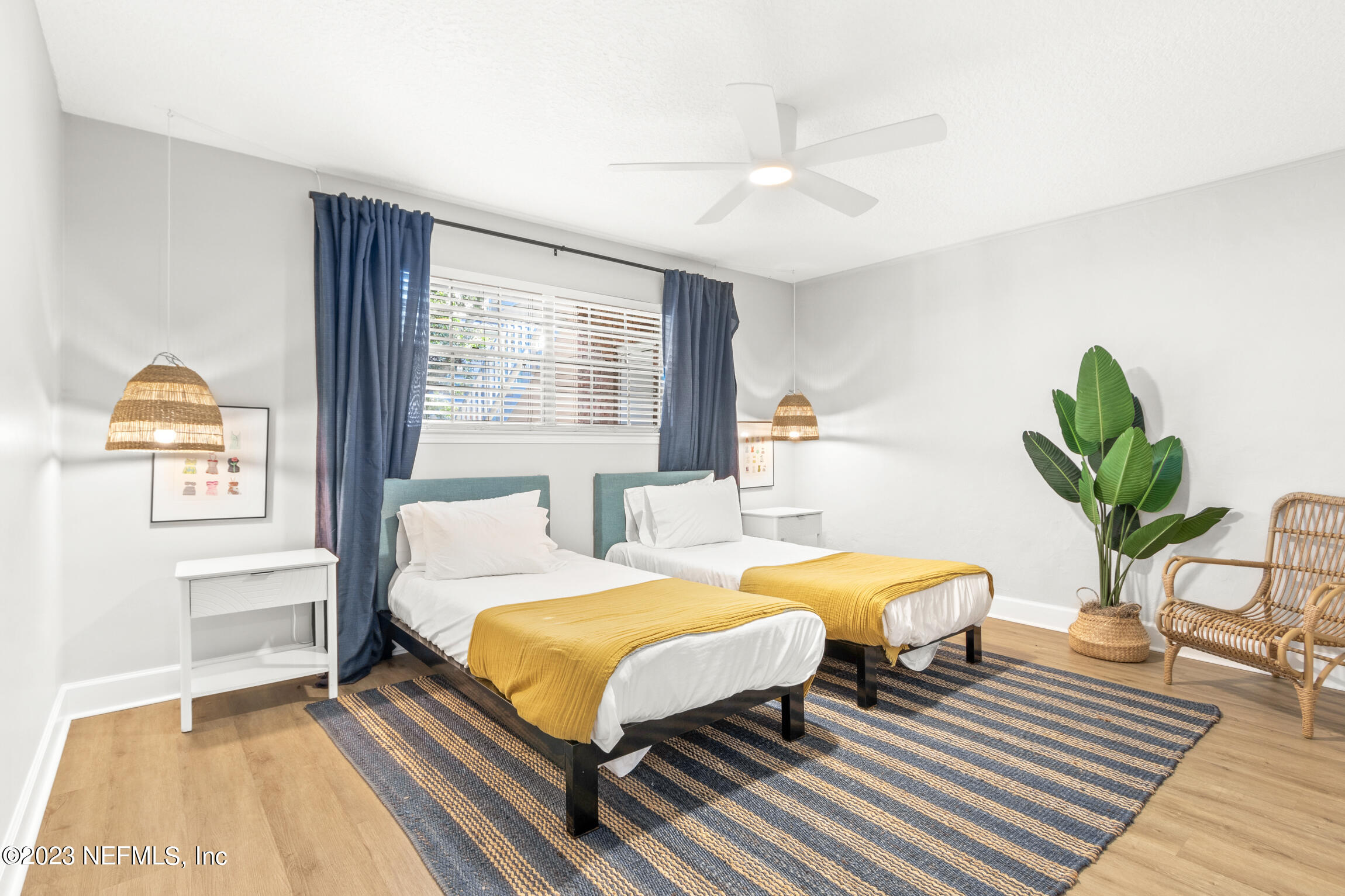 405 Flagler Boulevard, Unit 2A St. Augustine, FL 32080 - Photo 17 of 30 a bedroom with a bed and wooden floor