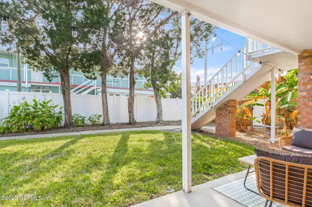a view of a house with a yard and plants