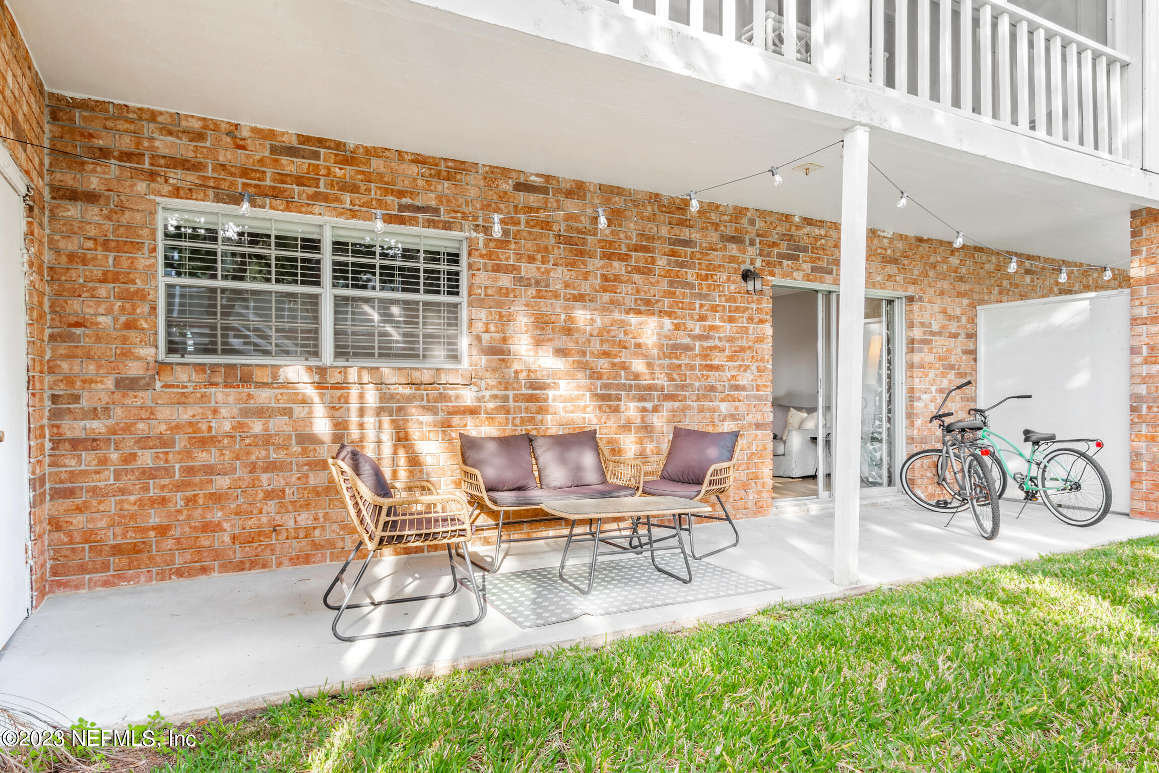 405 Flagler Boulevard, Unit 2A St. Augustine, FL 32080 - Photo 20 of 30 a view of a patio with table and chairs and potted plants