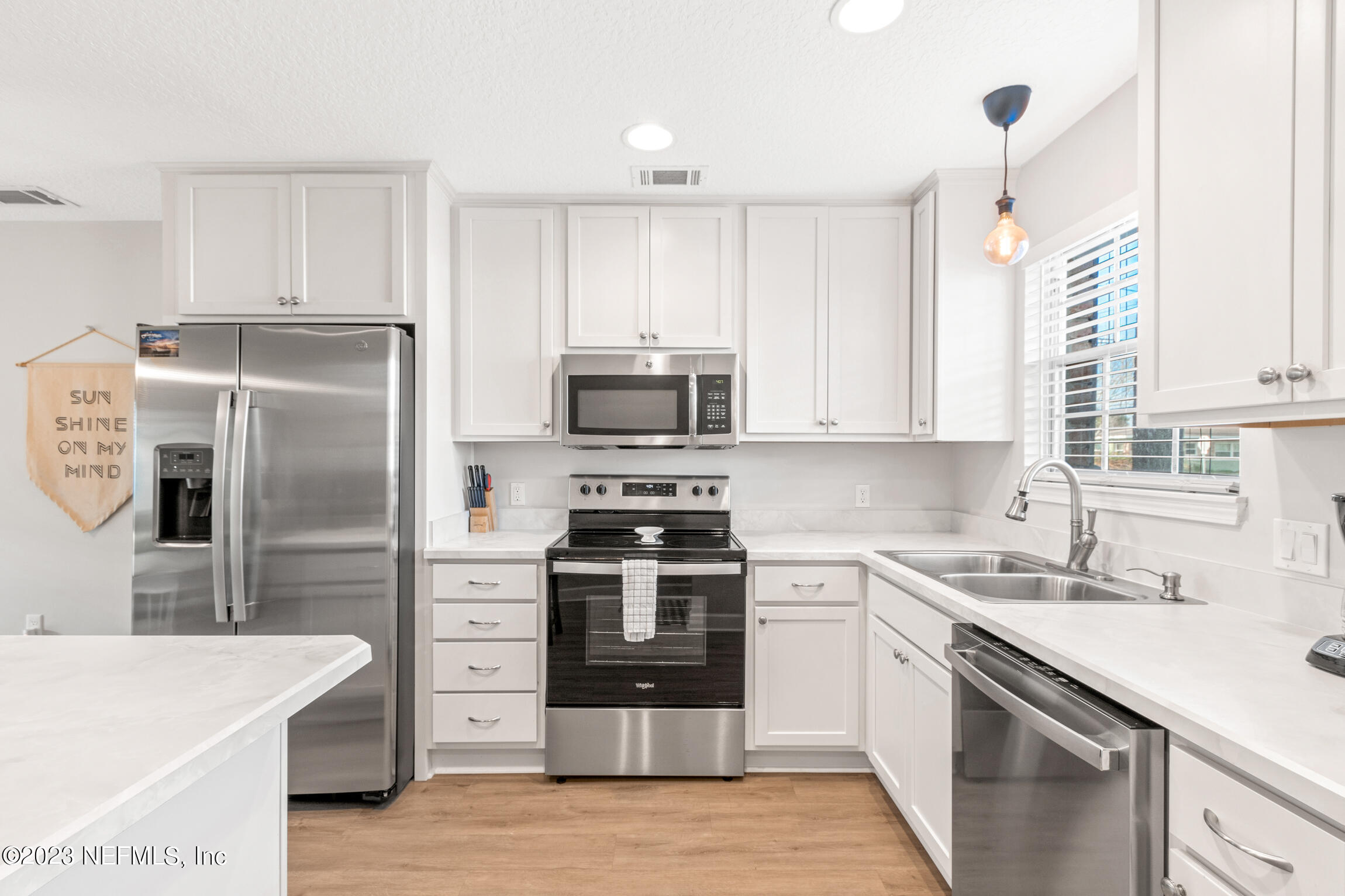 405 Flagler Boulevard, Unit 2A St. Augustine, FL 32080 - Photo 5 of 30 a kitchen with a sink stove and refrigerator