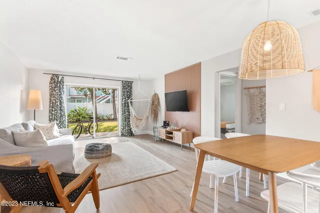 a living room with furniture a flat screen tv and a large window