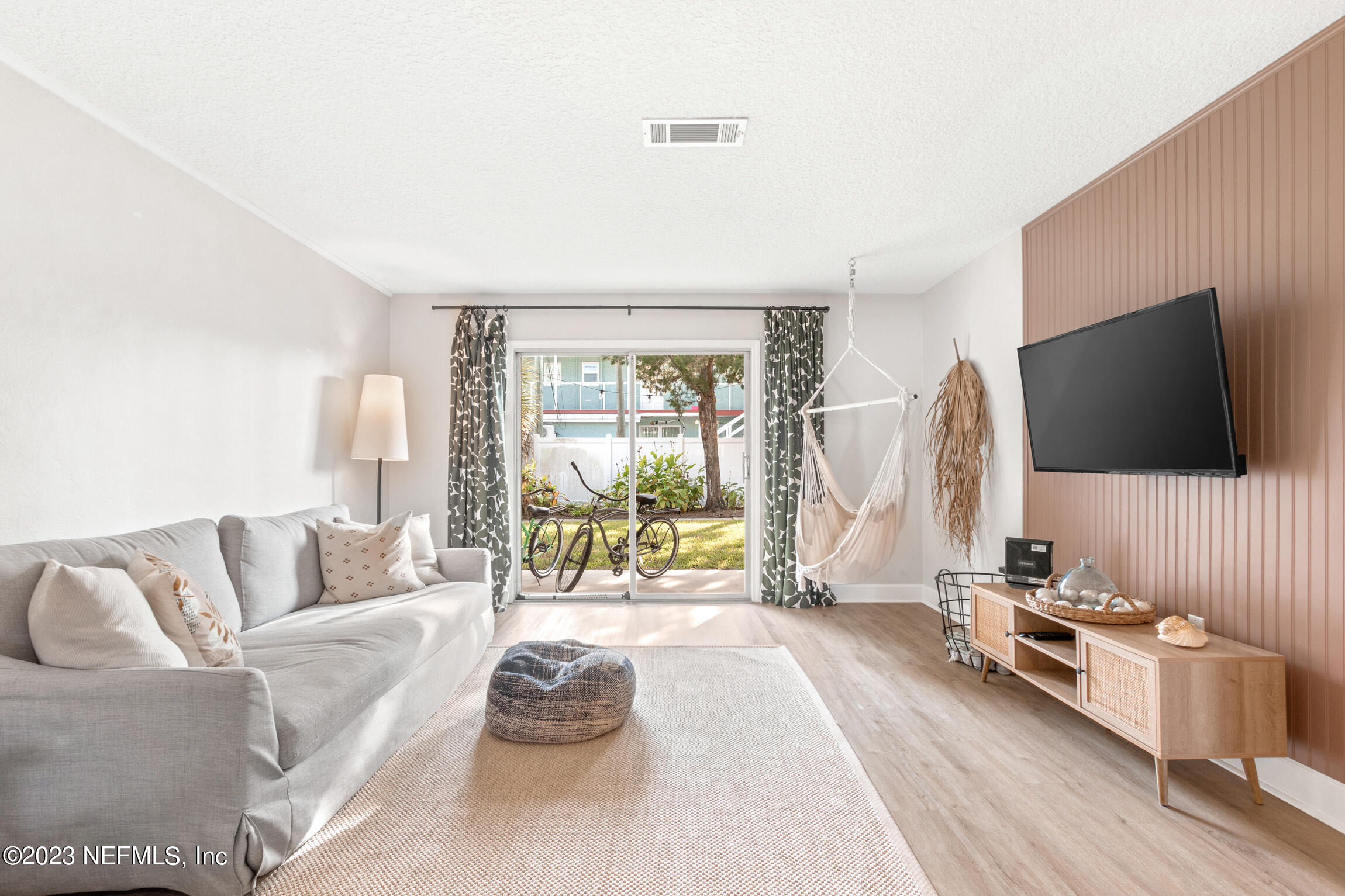 405 Flagler Boulevard, Unit 2A St. Augustine, FL 32080 - Photo 10 of 30 a living room with furniture and a flat screen tv