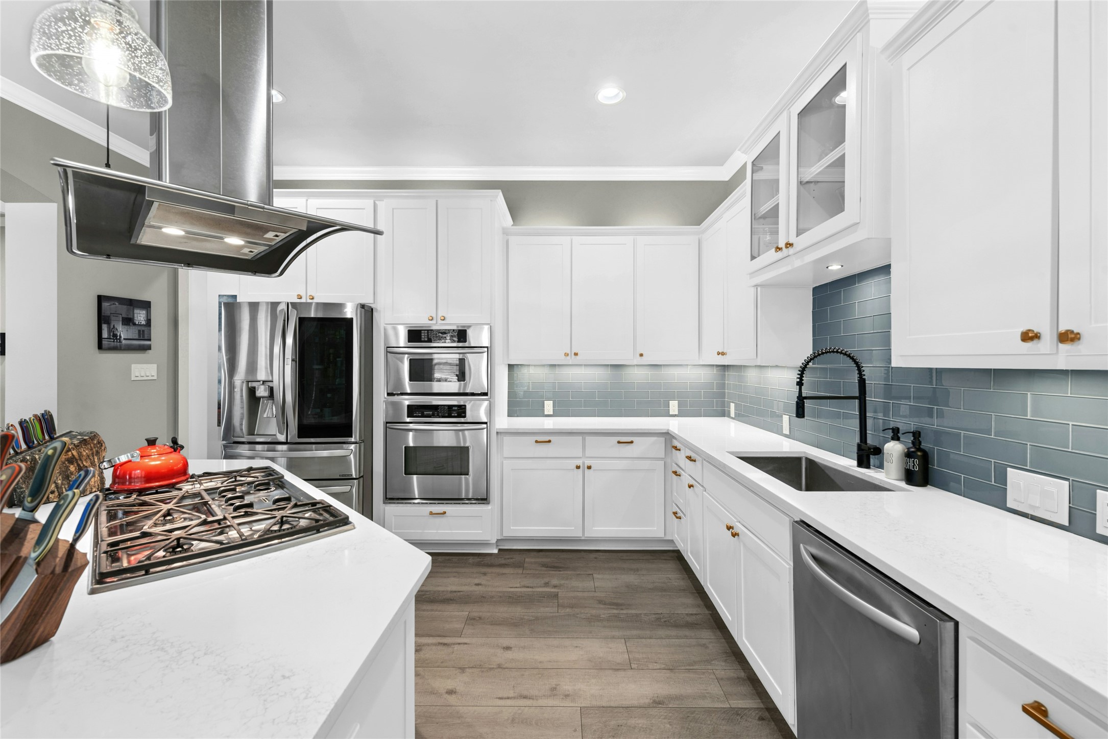 279 Rugged Earth Drive Austin, TX 78737 - Photo 15 of 40 a kitchen with stainless steel appliances granite countertop a sink stove and cabinets