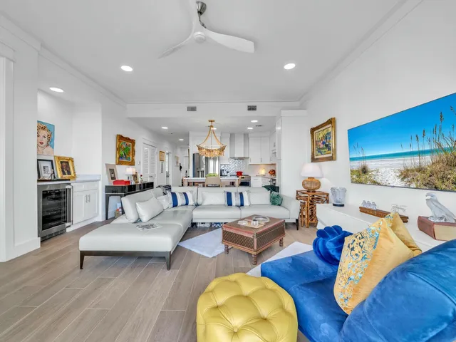 a kitchen with stainless steel appliances granite countertop a sink a stove a refrigerator and island