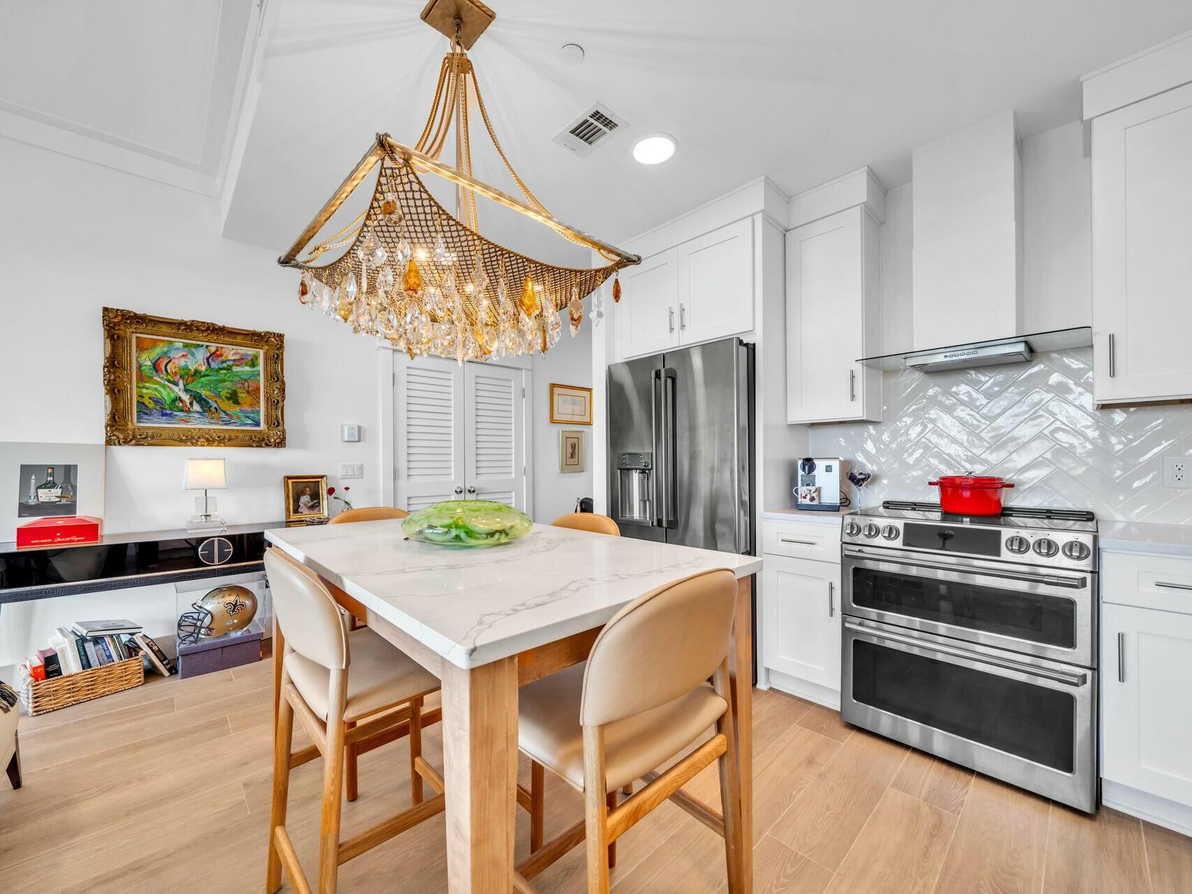 206 Henderson Resort Way, Unit 5202 Destin, FL 32541 - Photo 15 of 55 a kitchen with stainless steel appliances granite countertop a sink a stove a refrigerator and a dining table