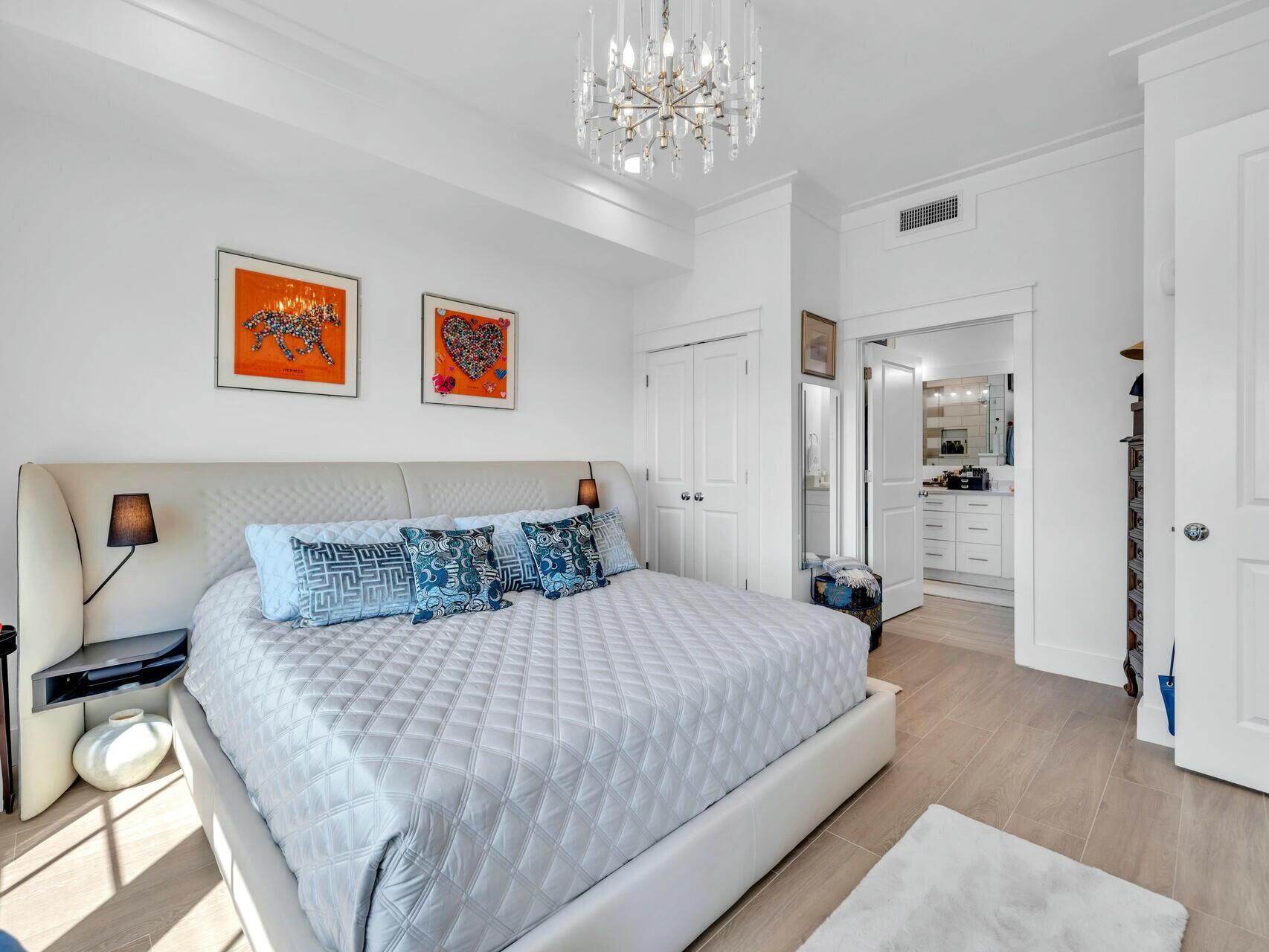 206 Henderson Resort Way, Unit 5202 Destin, FL 32541 - Photo 20 of 55 a bedroom with a large bed a chandelier and closet