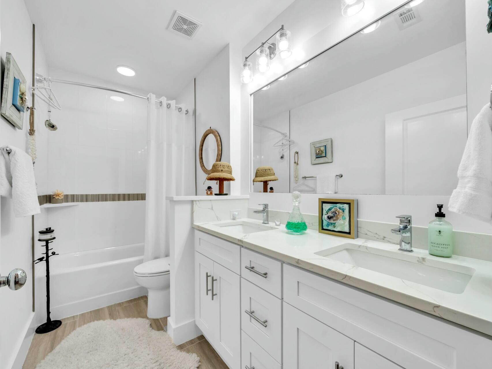 206 Henderson Resort Way, Unit 5202 Destin, FL 32541 - Photo 31 of 55 a spacious bathroom with a granite countertop sink mirror bathtub and toilet