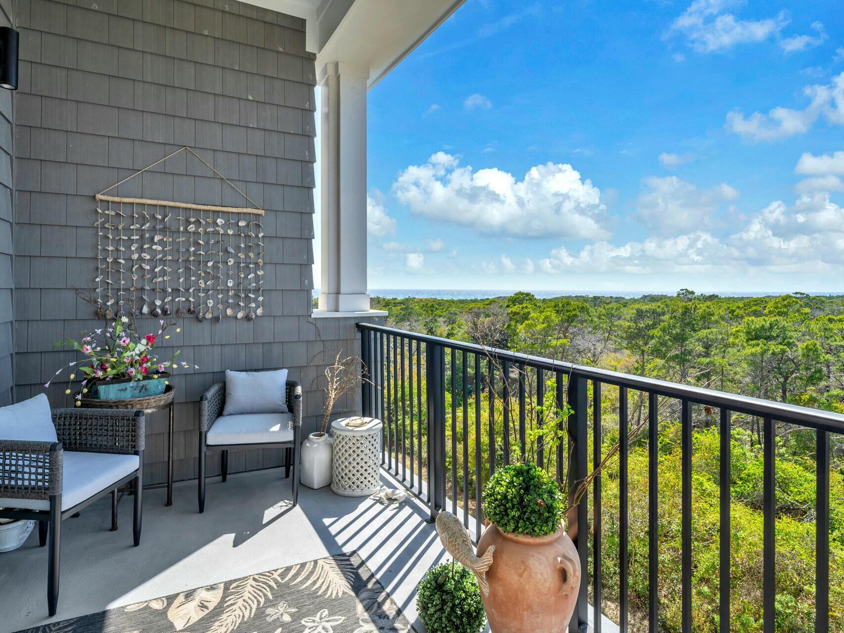 206 Henderson Resort Way, Unit 5202 Destin, FL 32541 - Photo 36 of 55 a view of a balcony with chair and potted plants