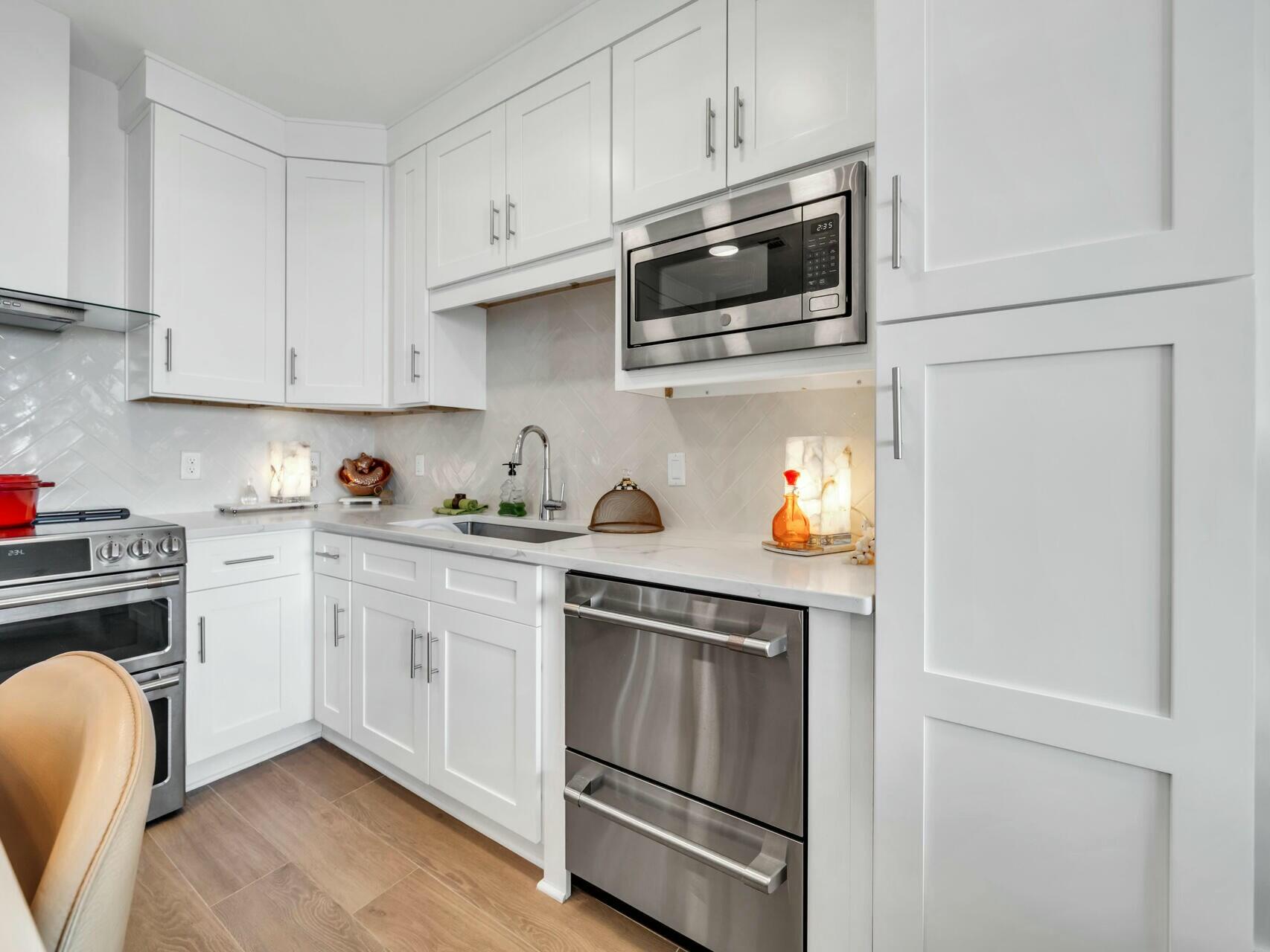 206 Henderson Resort Way, Unit 5202 Destin, FL 32541 - Photo 7 of 55 a kitchen with stainless steel appliances granite countertop white cabinets a sink and dishwasher