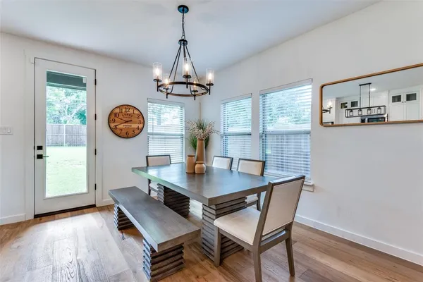 a view of a dining room with a table and chairs