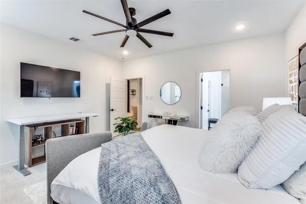 a living room with a bed furniture and a flat screen tv