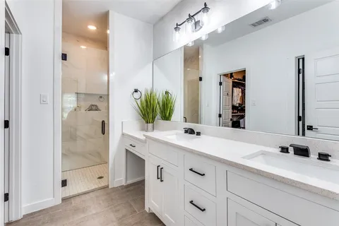 a bathroom with a shower sink and mirror