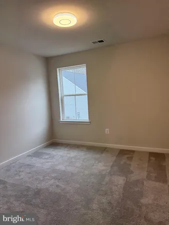 an empty room with a empty space and windows