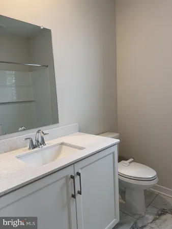 a bathroom with a sink a toilet and mirror