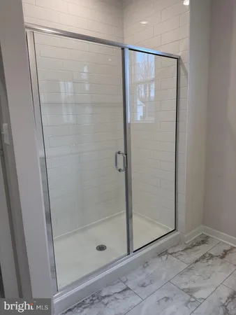 a bathroom with a glass shower door