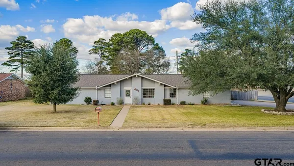 a view of a house with a swimming pool and a yard