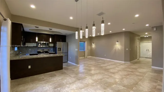 a kitchen with a refrigerator and a sink