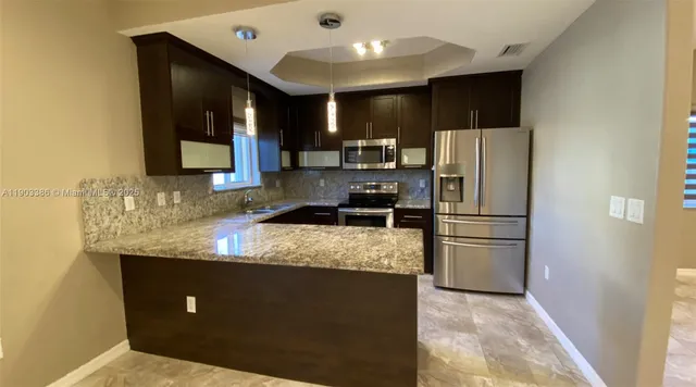 an empty room with chandelier fan