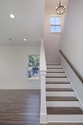 a view of entryway and hall with wooden floor