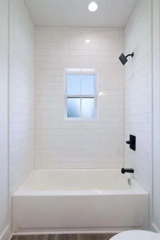 a bathroom with a bathtub and a shower