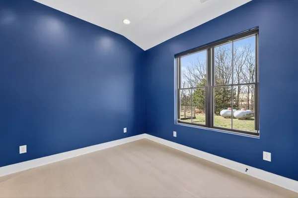 a living room filled with furniture and a large window