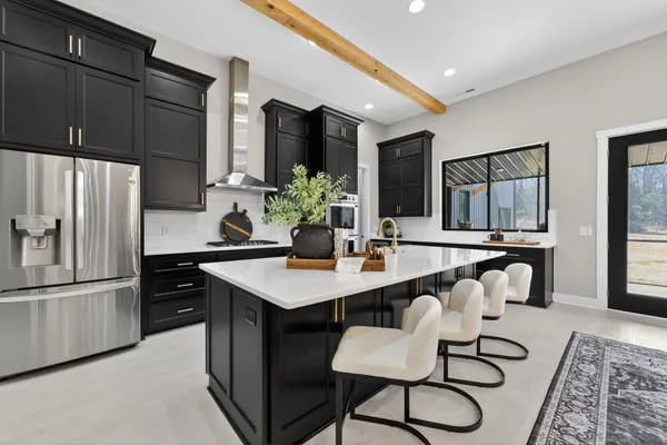 a kitchen with stainless steel appliances a sink and a refrigerator