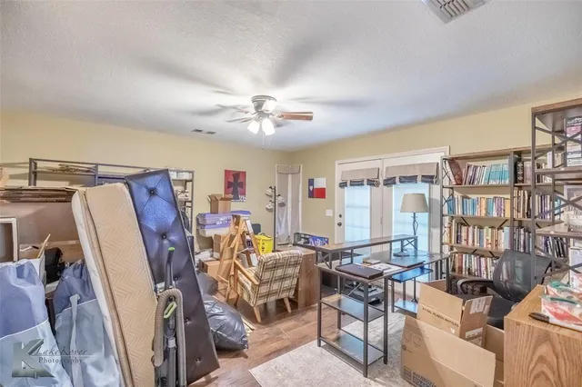 a view of a livingroom with furniture and workspace
