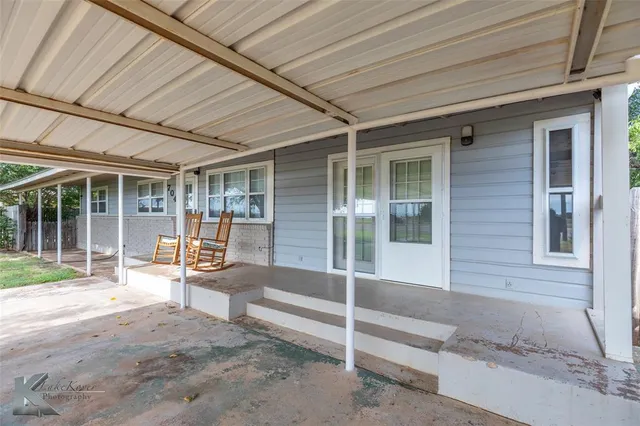 a house with wooden bench in front of it
