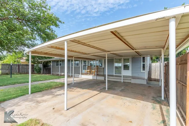a view of a house with a small garden and floor to ceiling window