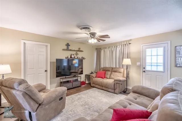 a living room with furniture and a flat screen tv