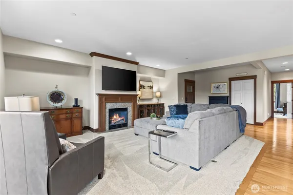 a living room with furniture a fireplace and a flat screen tv