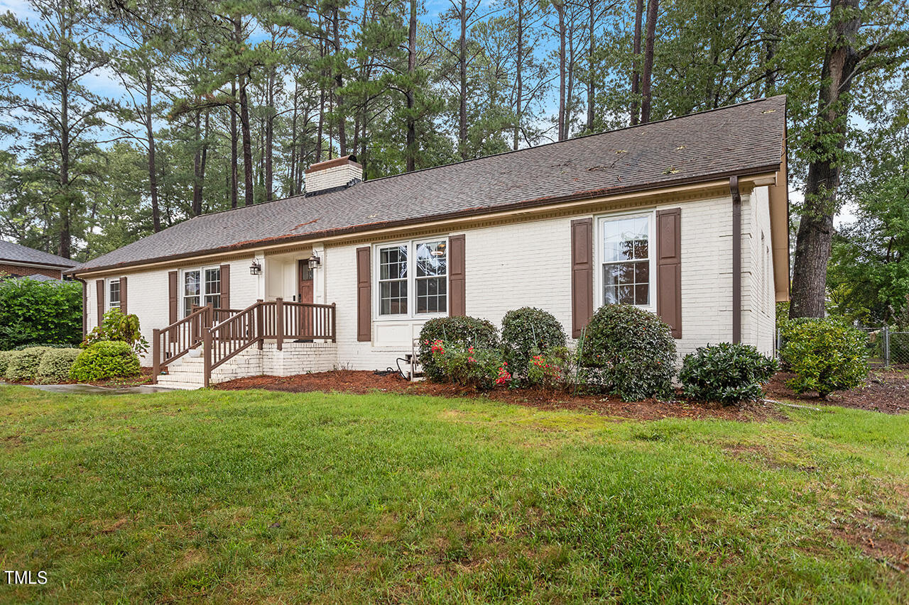 a view of a house with a yard and porch