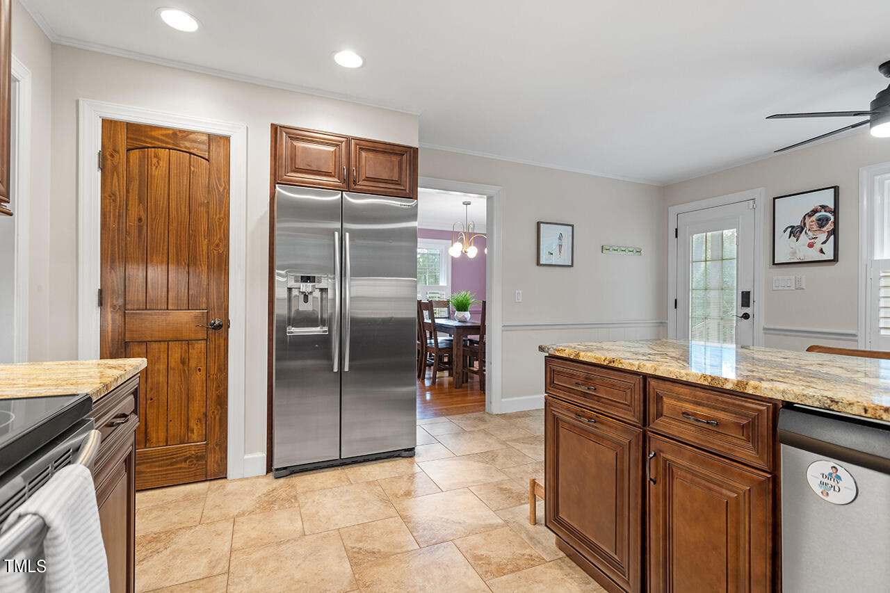 4918 Quail Hollow Drive Raleigh, NC 27609 - Photo 13 of 36 a kitchen with stainless steel appliances granite countertop a refrigerator and a sink