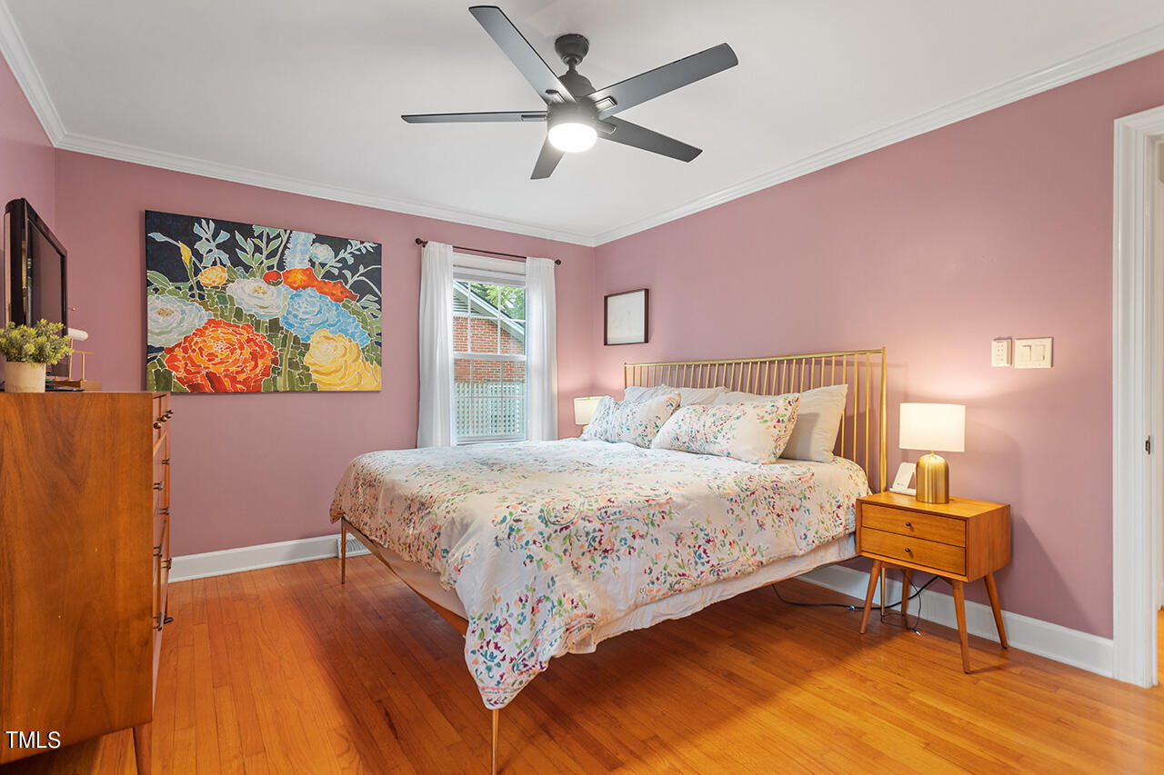 4918 Quail Hollow Drive Raleigh, NC 27609 - Photo 22 of 36 a bedroom with a bed and a painting on the wall