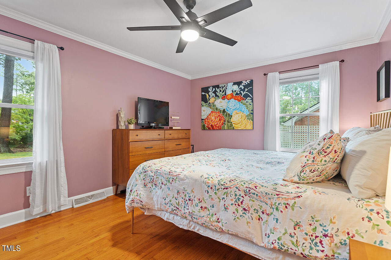 4918 Quail Hollow Drive Raleigh, NC 27609 - Photo 23 of 36 a bedroom with a bed and a flat screen tv