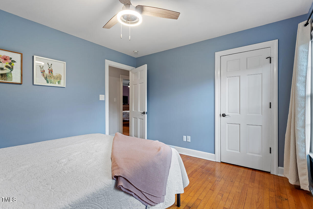4918 Quail Hollow Drive Raleigh, NC 27609 - Photo 29 of 36 a bed room with a bed and a chandelier