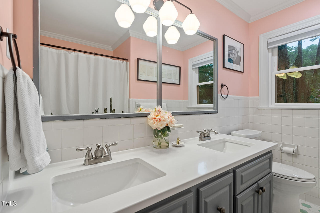 4918 Quail Hollow Drive Raleigh, NC 27609 - Photo 30 of 36 a bathroom with a sink and a mirror