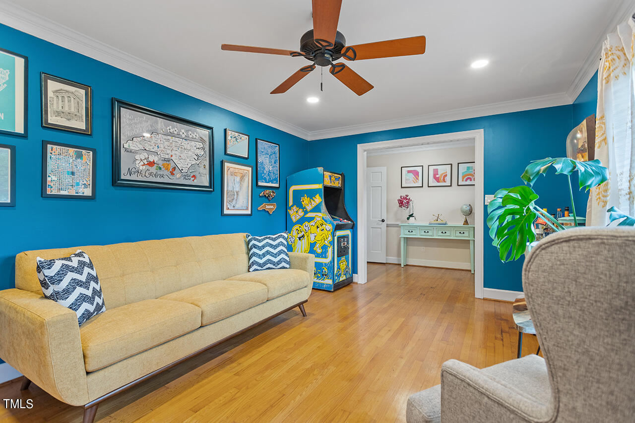 4918 Quail Hollow Drive Raleigh, NC 27609 - Photo 7 of 36 a living room with furniture and a chandelier