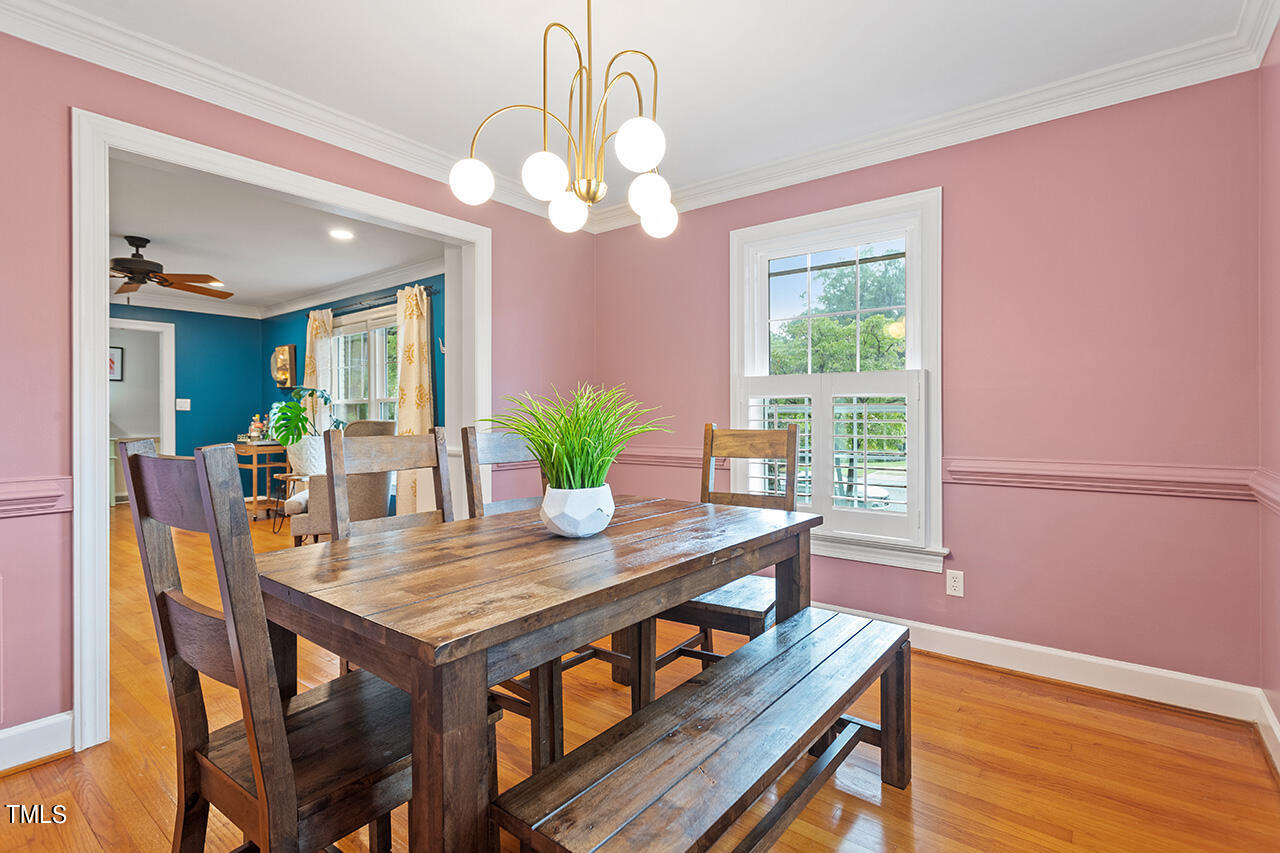 4918 Quail Hollow Drive Raleigh, NC 27609 - Photo 9 of 36 a view of a dining room with furniture window and wooden floor